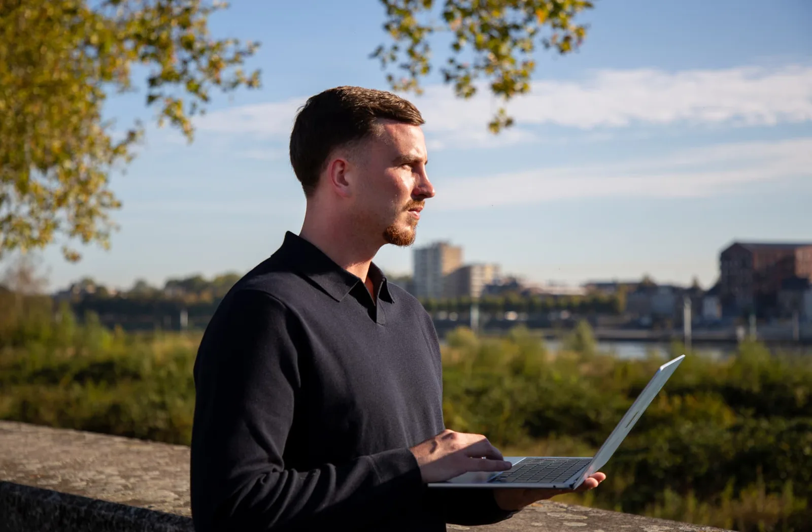 Gielke Huijs met zijn laptop aan de Maas in Venlo